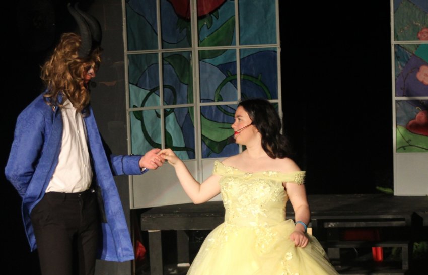 John Harvey, portraying Beast/Prince Adam, and Posey Palmer, portraying Belle, dance during a recent performance of “Beauty and the Beast.”